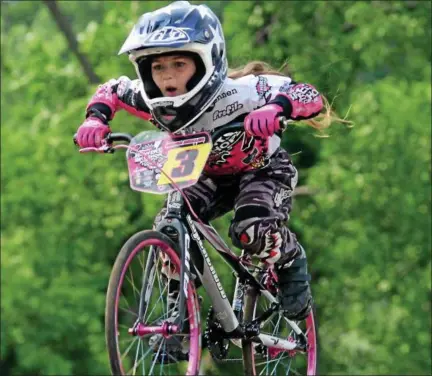  ?? PHOTOS BY TANIA BARRICKLO — DAILY FREEMAN ?? Jenna Miller of Saugerties keeps her eyes trained on the track during recent training session at Kingston Point BMX.