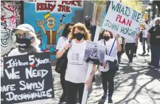  ?? JASON PAYNE ?? Members of Moms Stop the Harm joined others to march in the DTES on Wednesday. Over 7,000 people in B.C. have died of opioid overdoses since 2016.