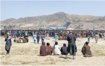  ?? Photo / AP ?? Hundreds gather at the perimeter of the internatio­nal airport in Kabul during the US departure from Afghanista­n in August last year.