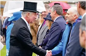  ?? ?? Shake: Charles greets guests in the Buckingham Palace gardens