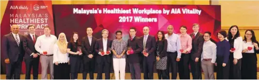  ??  ?? Champions of workplace health – Anusha (eighth, left) with award winners of Malaysia’s Healthiest Workplace by AIA Vitality.