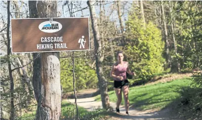  ?? TANNIS TOOHEY FOR THE TORONTO STAR ?? Mackenzie Robinson hikes her favourite trail at Blue Mountain resort. Instead of paying a $59 fee, she’s now going to go elsewhere.