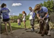  ?? BILL O’LEARY — WASHINGTON POST ?? Kristie Bradley of Newcastle, Oklahoma, with Bandit, the family dog, spends time with her children, from left, Leah, 11, Cooper, 3, Macy, 7, and Colton, 9, on a Friday, now that they no longer have school that day because of budget cuts.