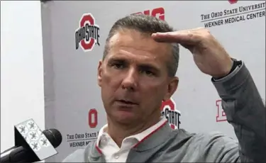  ?? MITCH STACY — THE ASSOCIATED PRESS ?? Ohio State NCAA college football head coach Urban Meyer gestures while speaking at a press conference in Columbus, Ohio, Monday.