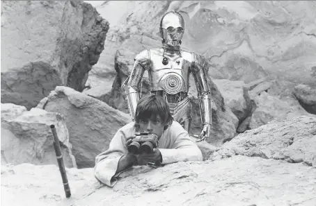  ??  ?? Luke Skywalker (Mark Hamill) and C-3P0 are startled to see vicious Tusken Raiders following their trail. After private screenings of Star Wars in early 1977, some 20th Century Fox executives and fellow directors saw flaws in the film, and questioned whether it could succeed.