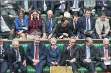  ?? JESSICA TAYLOR VIA REUTERS ?? British Prime Minister Theresa May (middle at front) reacts during a debate on extending the Brexit negotiatin­g period in Parliament in London on Thursday.