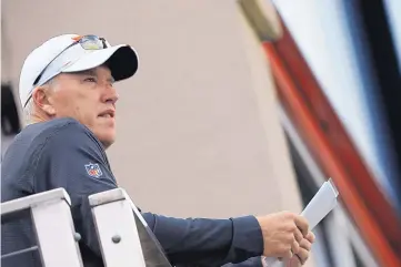  ?? DAVID ZALUBOWSKI/ASSOCIATED PRESS ?? Denver Broncos general manager John Elway, a Hall of Fame quarterbac­k, looks on during a joint practice with the Broncos and San Francisco 49ers on Friday.