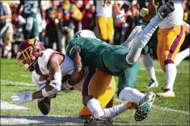  ?? GREGORY SHAMUS/GETTY IMAGES ?? Michigan State cornerback Justin Layne, here tackling Central Michigan receiver Julian Hicks, could be a second-round target of the Browns. The Cleveland native has campaigned for the Browns to bring him home.