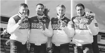  ??  ?? This file photo shows (From left) Gold Medallists, Russia-1 four-man bobsleigh, pilot Alexander Zubkov, pushman Aleksei Negodaylo, pushman Dmitry Trunenkov and brakeman Alexey Voevoda celebratin­g at the Bobsleigh Four-man Medal Ceremony at the Sanki Sliding Centre during the Sochi Winter Olympics. — AFP photo