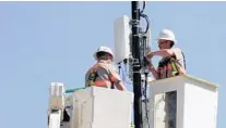  ?? VERIZON/COURTESY ?? Verizon Wireless workers install a “small cell” 5G wireless data service node on a utility pole in Indianapol­is. The city will be the first metro area where Verizon plans to offer the ultra-fast service, in late 2018.