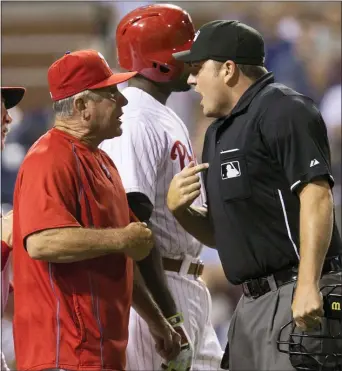  ?? THE ASSOCIATED PRESS FILE ?? From player to base coach to manager to bench coach over his several-tenured Phillies career, Larry Bowa never stopped having nice chats with umpires., such as this 2015 conversati­on with home plate umpire Dan Bellino.