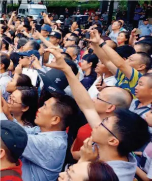  ??  ?? June 7, 2017: On the first morning of the gaokao, parents are waiting right outside an exam site with their cellphones ready to take photos as soon as the kids walk out.