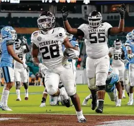  ?? Lynne Sladky / Associated Press ?? A&M running back Isaiah Spiller (28) and offensive tackle Kenyon Green (55) have signed deals allowed by the NCAA’s new name, image and likeness rules.