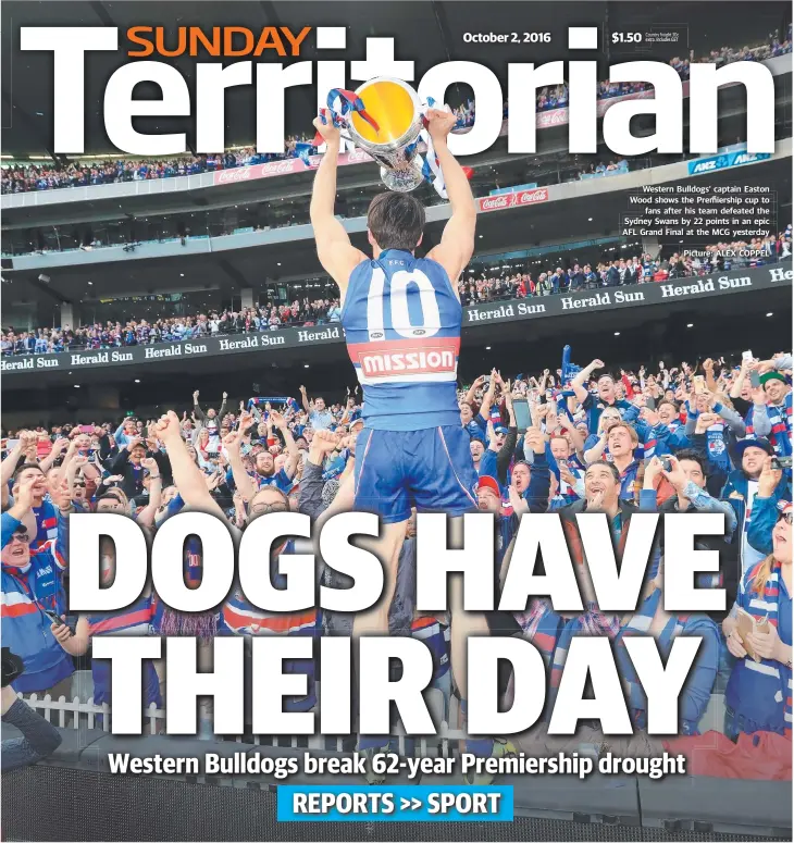  ?? Picture: ALEX COPPEL ?? Western Bulldogs’ captain Easton Wood shows the Premiershi­p cup to fans after his team defeated the Sydney Swans by 22 points in an epic AFL Grand Final at the MCG yesterday