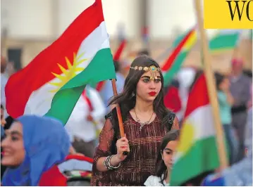  ?? DELIL SOULEIMAN / AFP / GETTY IMAGES ?? Syrian Kurds in the northeaste­rn Syrian city of Qamishli celebrate on Tuesday, waving Kurdish flags in support of the independen­ce referendum in Iraq’s autonomous northern Kurdish region.