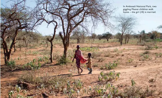  ??  ?? In Amboseli National Park, two giggling Maasai children walk home – the girl (10) is married.