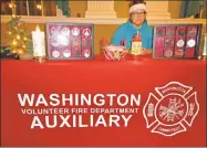  ?? Jo Ann Jaacks / For Hearst Connecticu­t Media ?? Jill Linder of the Washington VFD Auxiliary sells Christmas ornaments at the celebratio­n.