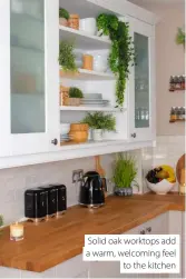  ?? ?? Solid oak worktops add a warm, welcoming feel to the kitchen