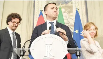  ?? — AFP photo ?? Di Maio (centre) flanked by Danilo Toninelli (left), president of the M5S group at the Senate and Giulia Grillo, president of the M5S group at the Parliament, speaks to the press after a meeting with Mattarella at the Quirinale palace in Rome.