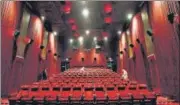  ?? SANJEEV VERMA/HT ARCHIVE ?? Workers disinfect a cinema hall in DLF Promenade mall at Vasant Kunj in July last year.