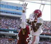  ?? STREETER LECKA / GETTY IMAGES ?? Alabama’s Tua Tagovailoa threw five touchdown passes Saturday — this one to DeVonta Smith — to easily defeat South Carolina in Columbia.