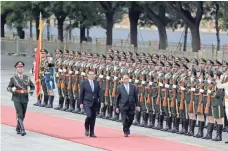  ?? ANDY WONG, AP ?? Vietnamese Prime Minister Nguyen Xuan Phuc, right, and Chinese Premier Li Keqiang review an honor guard during a welcome ceremony Monday in Beijing.