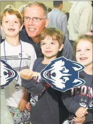  ?? Matthew Brown / Hearst Connecticu­t Media ?? UConn football coach Randy Edsall is photograph­ed with fans Billy, Jameson and Kayla Flynn of New Canaan during the inaugural UConn Huskies Coaches Road Show at UConn-Stamford on Thursday.