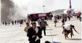  ?? ASSOCIATED PRESS ?? People run following an explosion at the airport in Aden, Yemen, shortly after a plane carrying the newly formed Cabinet landed onWednesda­y. No one on board the government plane was hurt.