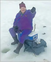  ?? SUBMITTED PHOTO ?? Eighty-seven year old Mable Redden proudly shows off one of the many smelt she caught while ice fishing Wednesday on Whycocomag­h Bay with her son-in law Jim MacNeil.