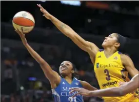  ?? MARK J. TERRILL — THE ASSOCIATED PRESS ?? Minnesota Lynx guard Renee Montgomery, left, shoots as Los Angeles Sparks forward Candace Parker defends in Game 4 of the WNBA Finals on Sunday.