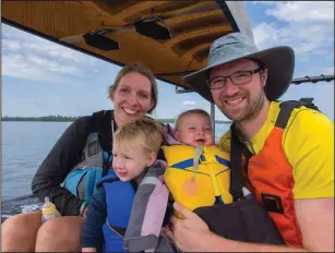  ?? Photo courtesy of Bobby Marko ?? From left, Maura, Jack, Rowan and Bobby Marko catch a ride across Moose Lake during a 2017 canoe camping trip in the Boundary Waters Canoe Area Wilderness in Minnesota.