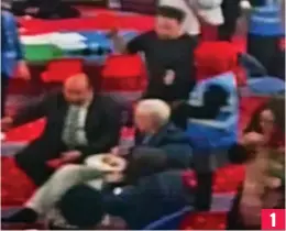  ??  ?? 1 CCTV footage shows Murphy (standing, in black) approachin­g a seated Mr Corbyn and slapping an egg into the side of his head