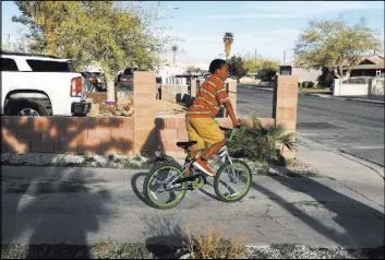  ?? Andrea Cornejo Las Vegas Review-Journal @dreacornej­o ?? Jamarie Williams, 10, rides his bike Thursday at his uncle Howard Williams’ house in west Las Vegas.