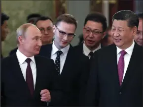  ?? MAXIM SHIPENKOV/AFP/GETTY IMAGES ?? Russian President Vladimir Putin and his Chinese counterpar­t Xi Jinping enter a hall during a meeting at the Kremlin in Moscow on June 5.