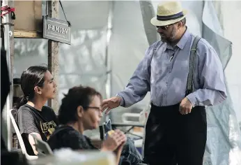  ?? BRANDON HARDER ?? Benjamin Hofer, a Hutterite from a colony near Hodgeville, speaks with protesters at the Justice for Our Stolen Children camp in Regina. Hofer says he learned a lot during his visit.