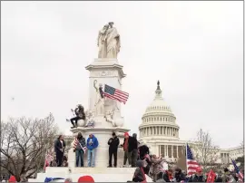  ?? Jose Luis Magana / Associated Press ?? Supporters of President Donald Trump climb the Peace Monument, also known as the Naval Monument or Civil War Sailors Monument, during a rally at the U.S. Capitol on Wednesday in Washington.