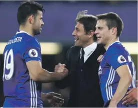  ??  ?? Chelsea coach Antonio Conte celebrates with Diego Costa and Cesar Azpilicuet­a Photo: AP