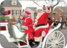  ?? Photo by Cary Beavers ?? Santa and Mrs. Claus wave to the crowds lining the streets in Bristol
