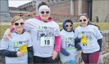  ??  ?? From left, 10-year-old Lukah Pothier, Andrea Pothier, 10-year-old Daeshawn Fletcher and Jillian Veinot, of Centrevill­e, get ready to get colourful at A Run to Dye For.
