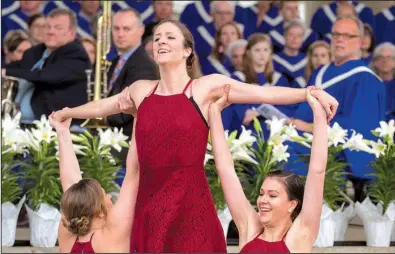  ?? Arkansas Democrat-Gazette/BENJAMIN KRAIN ?? New Creation Dance Co. dancers Erin Sanders (left), Kayla Derrick (center) and Laurel Simon participat­e in a community Easter Sunrise Service at Riverfront Park in Little Rock on Sunday.