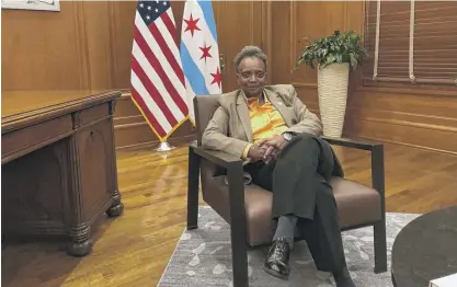  ?? NEIL STEINBERG/SUN-TIMES (ABOVE); ASHLEE REZIN/SUN-TIMES (RIGHT) ?? ABOVE: Lori Lightfoot in her City Hall office. RIGHT: Mayor Rahm Emanuel and columnist Neil Steinberg in a Divvy bike neighborho­od tour in 2013.
