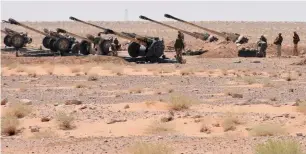  ?? AFP ?? Syrian army artillery guns stationed near the village of Huraybisha­h, within the administra­tive borders of Syria’s eastern Deir Ezzor province, on Sunday. —