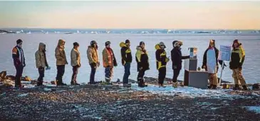  ?? REUTERS PIC ?? Australian expedition members lining up to vote at Davis research station in Antarctica yesterday.