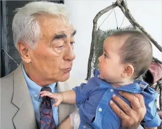  ??  ?? GENERATION IN HAND: John Havan at home with his great-grandson. Much of the basis for Havan’s ‘The Tiger General’ came from his experience­s in Vietnam before, during and after the war.