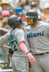  ?? MIKE MCGINNIS/AP ?? The Marlins’ Jazz Chisholm Jr celebrates with Jesus Aguilar after hitting a solo home run against the Padres on Sunday in San Diego.