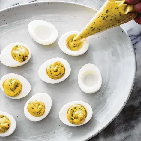  ?? Daniel J. van Ackere / Associated Press ?? America’s Test Kitchen’s deviled eggs use cider vinegar and Worcesters­hire sauce for pop.