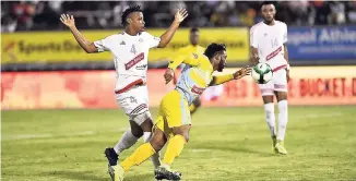  ?? RICARDO MAKYN/ MULTIMEDIA PHOTO EDITOr ?? Portmore’s Damano Solomon (left) tries his best not to foul Waterhouse player Andre McFarlane during the Red Stripe Premier League final at the National Stadium on Monday. Portmore won 4-3 on penalties after a 0-0 scoreline in regulation and extra time.