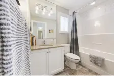  ??  ?? The main bathroom in the Cypress II show home features subway tiles.