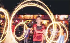  ?? HT PHOTO: SATISH BATE ?? A girl plays with sparklers at Girgaum on Saturday.