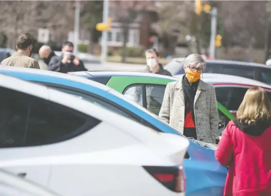  ?? BRANDON HARDER ?? Saskatoon Nutana MLA Erika Ritchie, second from right, speaks to electric vehicle owners who gathered in front of the Saskatchew­an Legislativ­e Building on Saturday to let the provincial government know they aren't happy with a $150 annual tax on their vehicles.